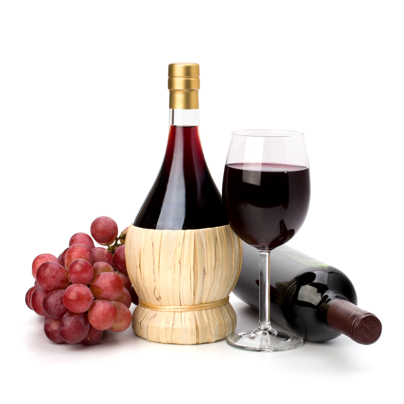 Full red wine glass goblet, bottle and grapes